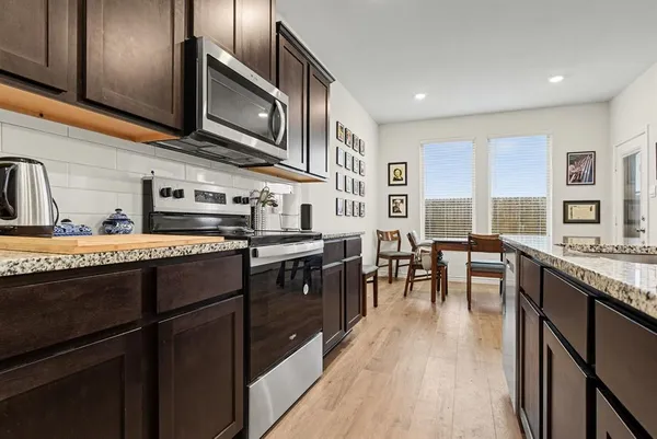 a kitchen with lots of counter top space and stainless steel appliances