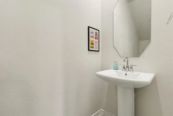 a bathroom with a sink and mirror