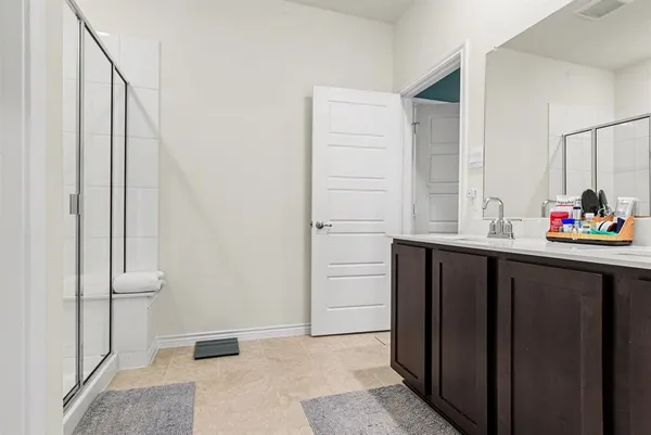a kitchen with granite countertop a refrigerator and cabinets