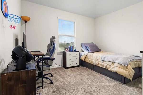 a bed room with a bed and a chair