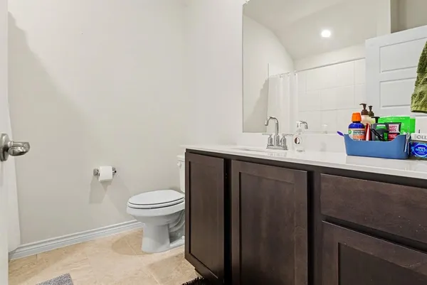 a bathroom with a sink toilet and a mirror