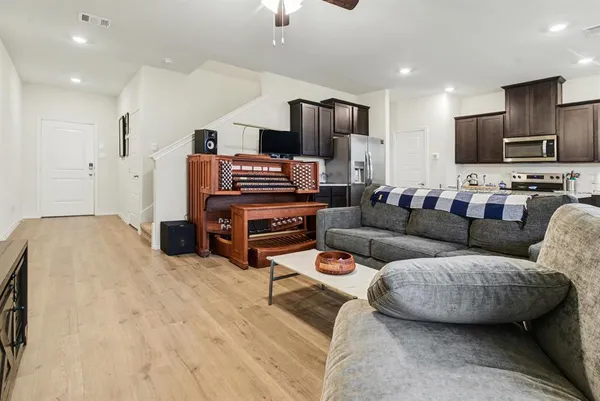 a living room with furniture and kitchen view