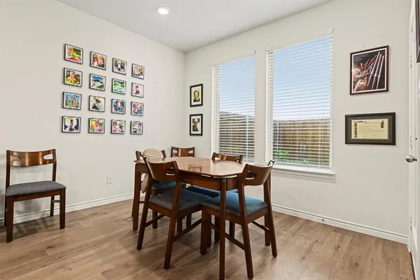 a view of a dining room with furniture and wooden floor