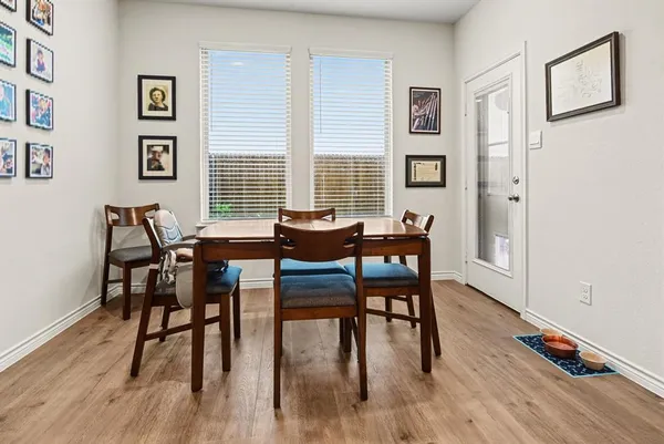 a view of a dining room with furniture and wooden floor