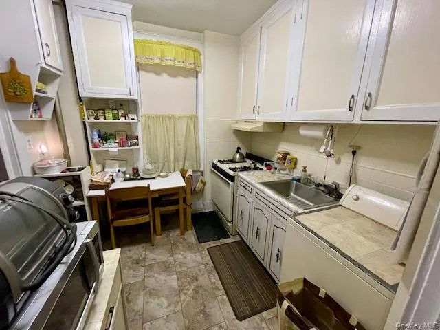 a kitchen with a stove a sink and a microwave