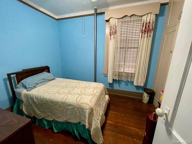 33-21 82nd Street, Unit 1 Queens, NY 11372 - Photo 8 of 11 a bed sitting in a bedroom next to a window