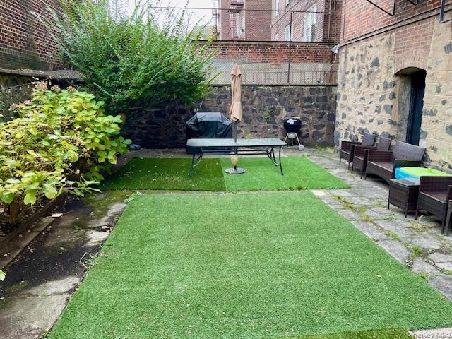 33-21 82nd Street, Unit 1 Queens, NY 11372 - Photo 10 of 11 a view of a chair in a patio with a yard