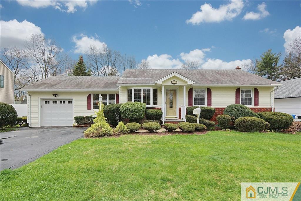 93 Morningside Road Colonia, NJ 07067 - Photo 1 of 23 a front view of a house with a yard and garage