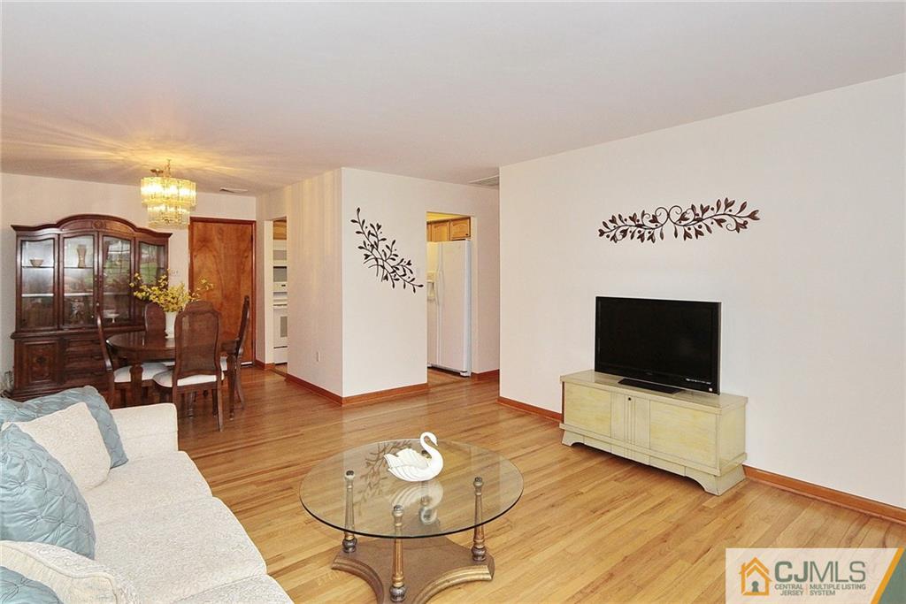 93 Morningside Road Colonia, NJ 07067 - Photo 4 of 23 a living room with furniture and a flat screen tv