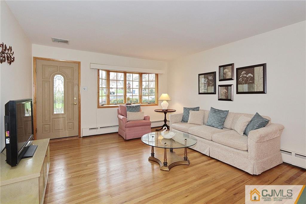 93 Morningside Road Colonia, NJ 07067 - Photo 5 of 23 a living room with furniture and a flat screen tv