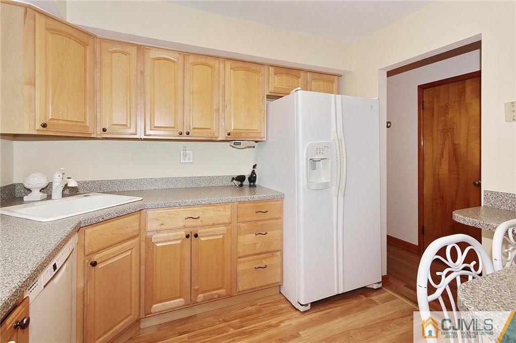 93 Morningside Road Colonia, NJ 07067 - Photo 9 of 23 a kitchen with granite countertop white cabinets and refrigerator