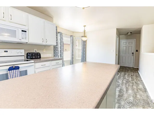 a view of kitchen with cabinets and wooden floor