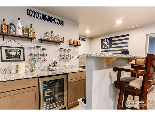a kitchen with stainless steel appliances kitchen island a table chairs in it and wooden floors