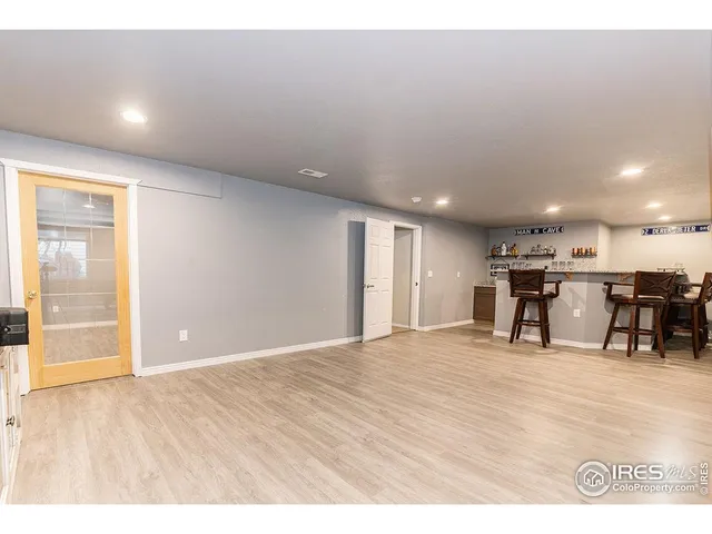 a room with pool table and windows
