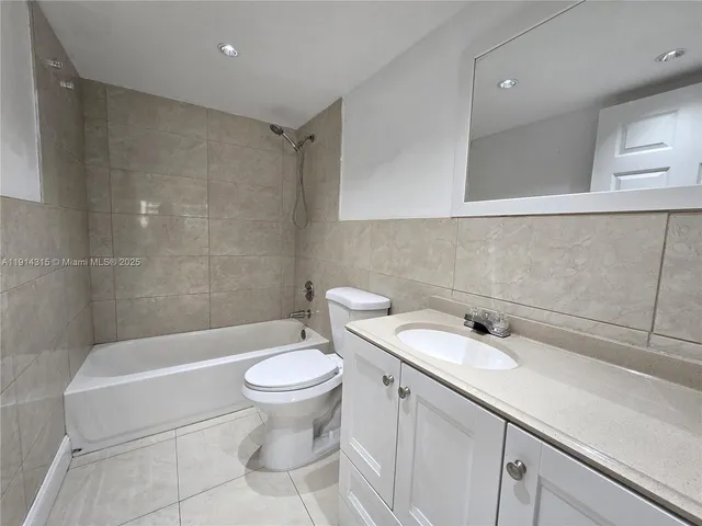 a bathroom with a sink a toilet and bathtub