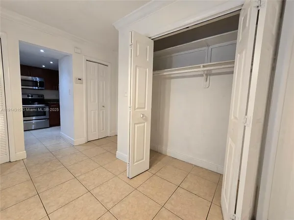 a view of an empty room and closet area