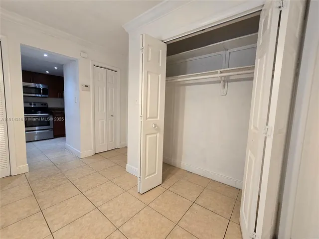 a view of an empty room and closet area