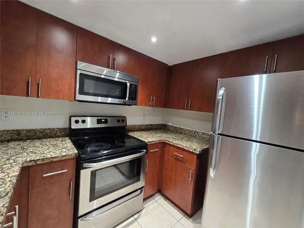a kitchen with a refrigerator stove and microwave