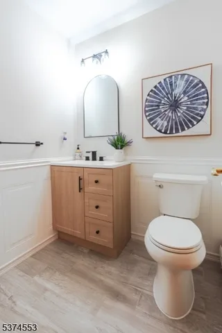 a bathroom with a toilet a sink and mirror