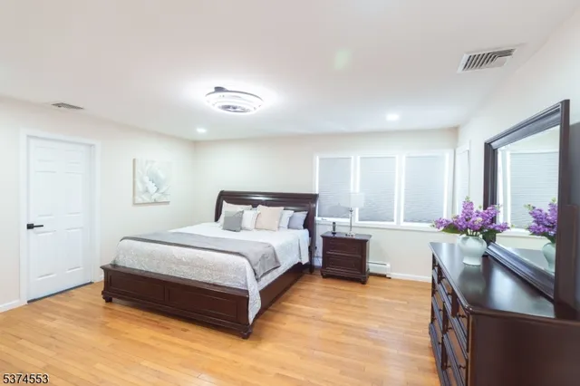 a spacious bedroom with a bed and window