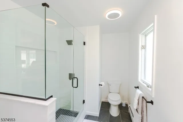 a bathroom with a toilet and a shower