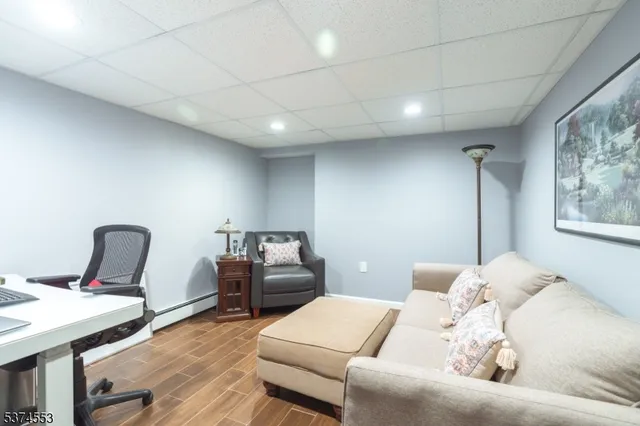 a bedroom with furniture and wooden floor