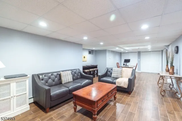 a living room with furniture a wooden floor and a chandelier