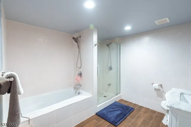 a bathroom with a bathtub and a shower