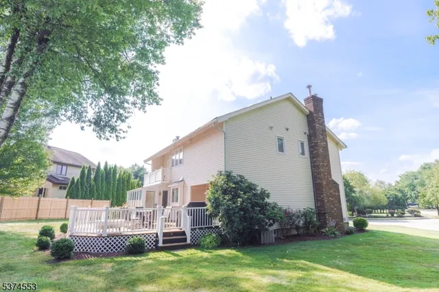 a view of backyard with barbeque grill and plants