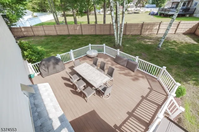 a view of a patio with a table chairs and a backyard