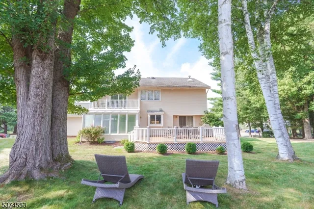 a front view of a house with a garden and patio