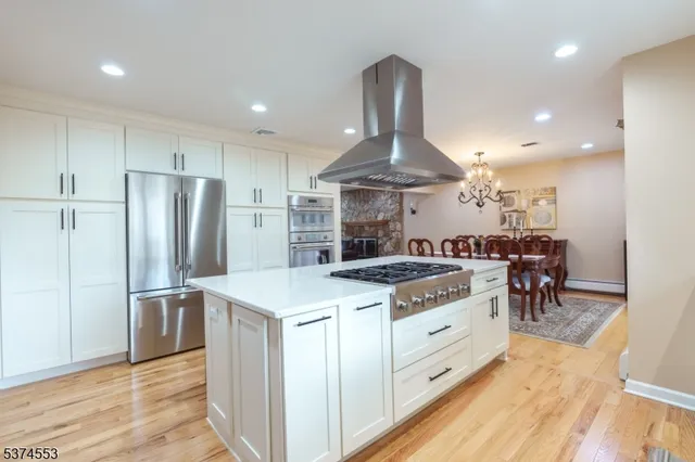 a kitchen with stainless steel appliances granite countertop a stove and a refrigerator