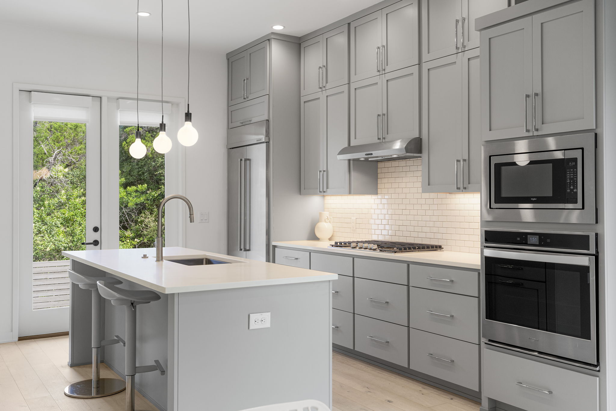 2520 Sutherland Street Austin, TX 78746 - Photo 2 of 26 Culinary delights await in this modern kitchen with sleek cabinetry and a sun-filled breakfast bar.