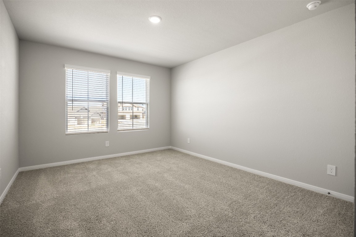 445 Cross Barn Boulevard, Unit B Buda, TX 78610 - Photo 12 of 18 an empty room with windows