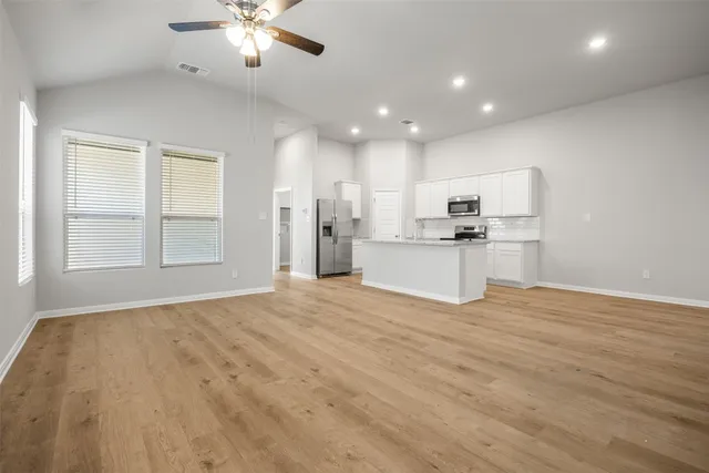 a view of kitchen with sink and refrigerator