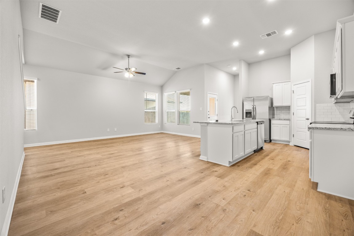 445 Cross Barn Boulevard, Unit B Buda, TX 78610 - Photo 18 of 18 a view of a kitchen with wooden floor and a kitchen
