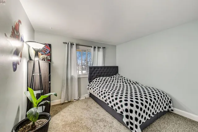 a bedroom with a bed and a book shelf