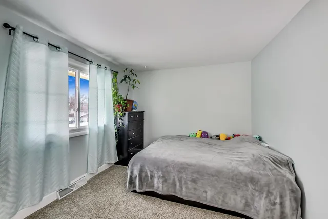 a bedroom with a bed and a walk in closet