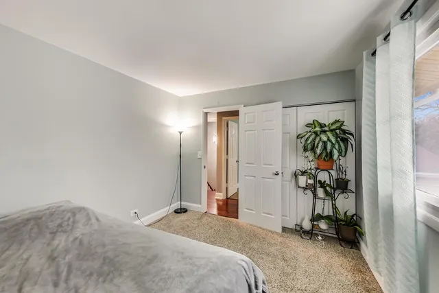 a bedroom with a bed and a painting on the wall