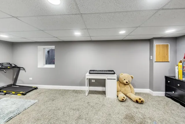 a room with gym equipment and a table