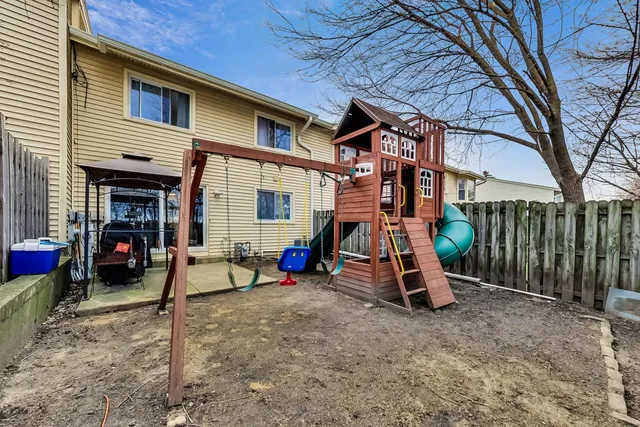 a view of a house with a patio and a slide