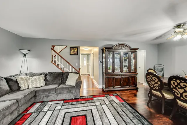 a living room with furniture a rug and a table