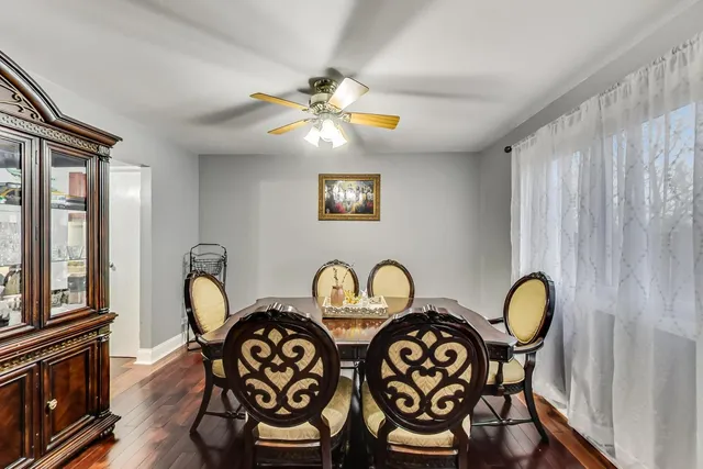a view of a dining room with furniture wooden floor and window