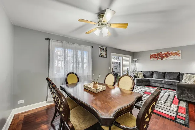 a view of a dining room with furniture and chandelier