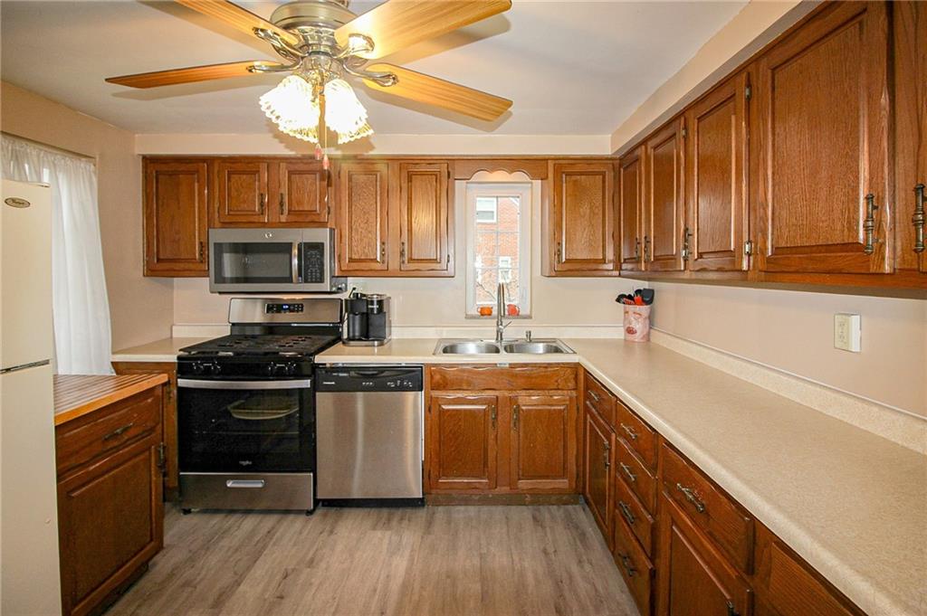 164 Gill Hall Road Clairton, PA 15025 - Photo 7 of 30 a kitchen with a sink stove top oven and cabinets