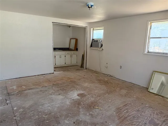an empty room with windows and closet