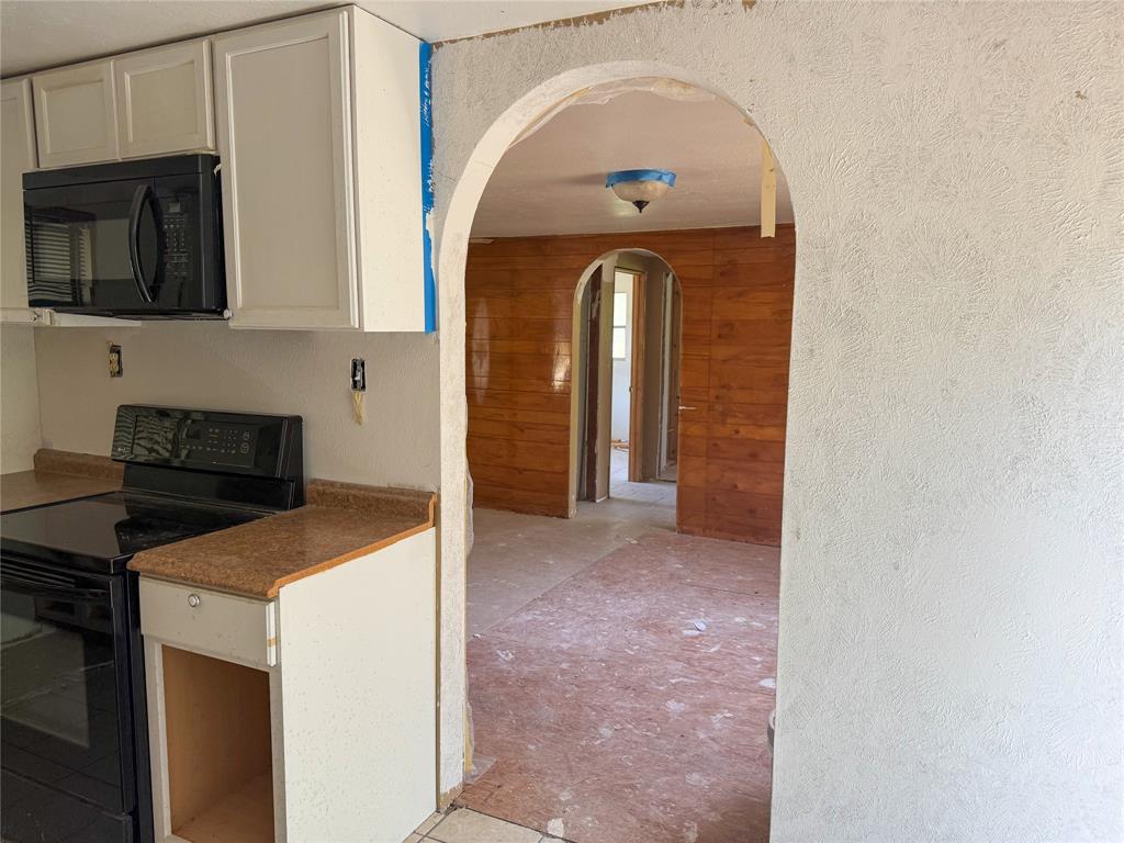 116 5th Street Whitney, TX 76692 - Photo 14 of 23 a view of a kitchen with stainless steel appliances granite countertop a stove a microwave and cabinets