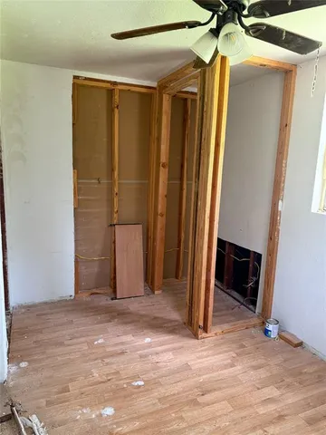 a view of a room with wooden floor and a fireplace