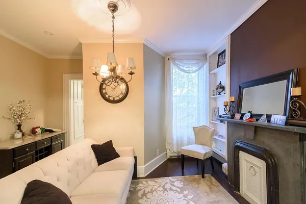 a living room with furniture a rug and a chandelier