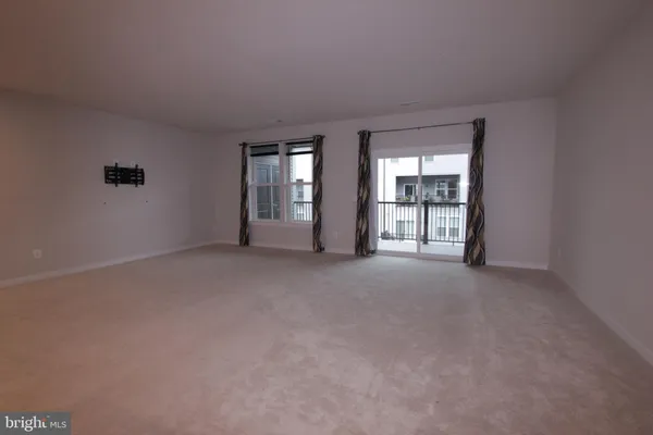 a kitchen with stainless steel appliances granite countertop wooden floors a stove and a microwave